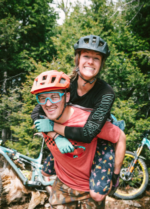 A mountain biking couple taking a break from the trail